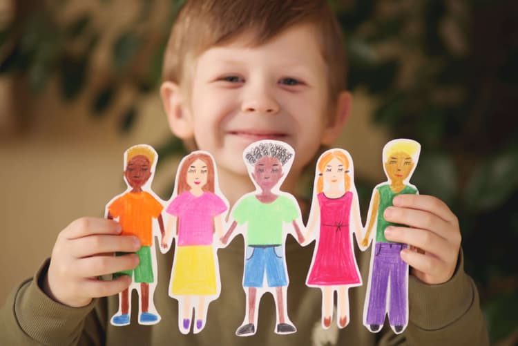 boy-holding-paper-homemade-garland-of-people-